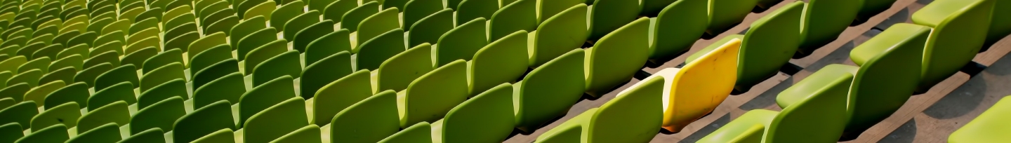 green stadium seating with single yellow seat