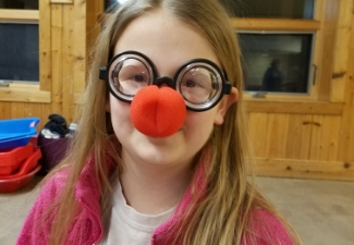 young girl with red clown nose